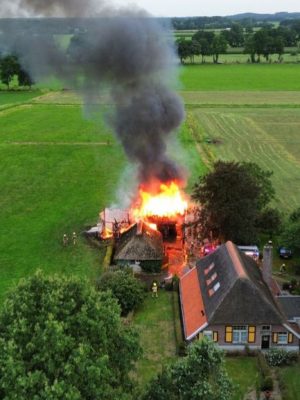 Grote brand verwoest schuur met zonnepanelen in Lochem, rietgedekte woning ternauwernood gespaard